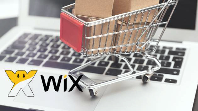 Logo Wix placé sur un ordinateur portable en même temps qu'un petit caddie plein.